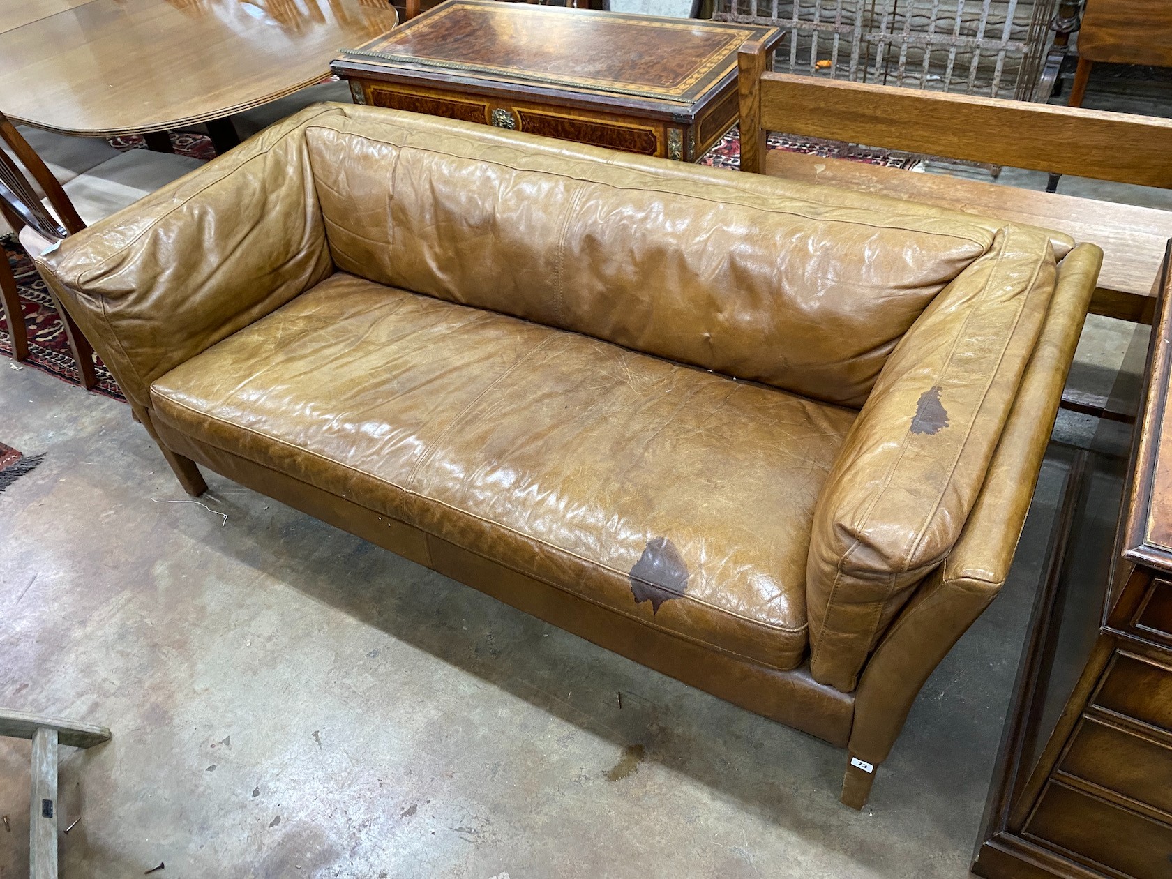 A contemporary tan leather two seater settee, length 180cm, depth 80cm, height 64cm